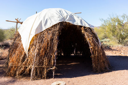 Native American Traditional Dwelling: Wigwam House, Home in Desert, Blue Sky and Bushes on...
