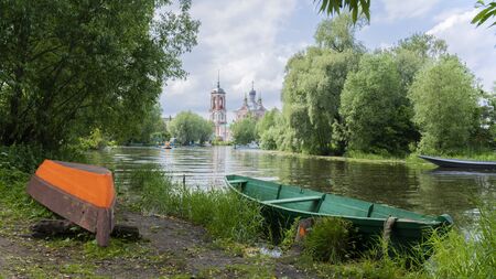 wooden boat on the river among the trees
