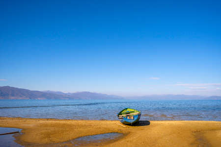 Wooden boat at pier on mountain lakeの写真素材