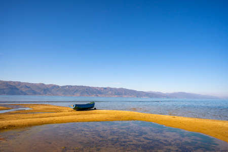 Wooden boat at pier on mountain lake