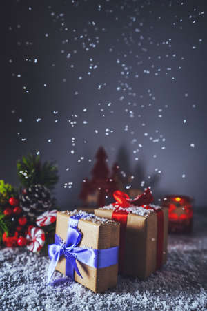 Beautiful Christmas gift boxes on the table whith snow in the room. Snowfallの写真素材