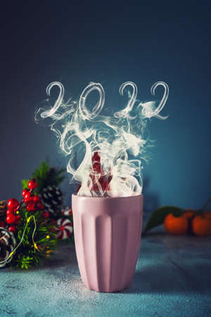 Cup of hot drink whith smoke. New year 2022 concept