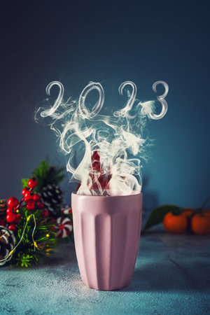 Cup of hot drink whith smoke. New year 2023 concept.の写真素材