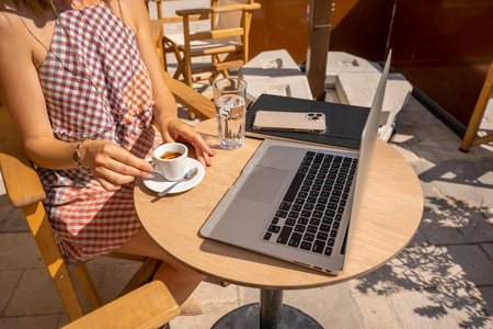 Wood desk table with laptop computer, cup of coffee and smartphone. Top view with copy space, flat lay. Working from cafe in the morning concept.の写真素材