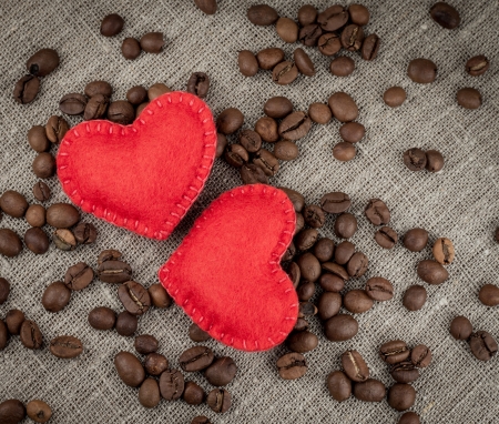Red hearts on coffee beans background.の写真素材