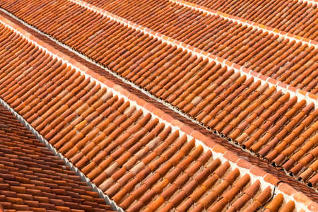 Abstract background of red tiles roofs in sunny day