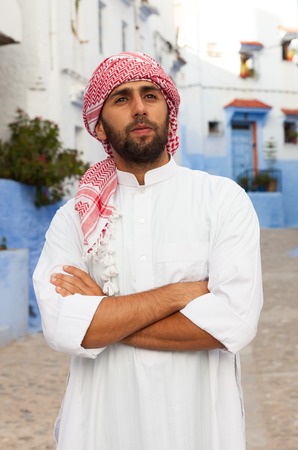 Young smiling handsome arabic man wearing traditional clothes