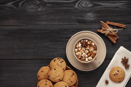 Hot cocoa and cookies on black tableの写真素材