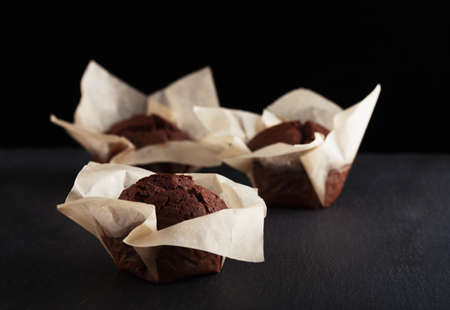 Chocolate muffins on black backgroundの写真素材