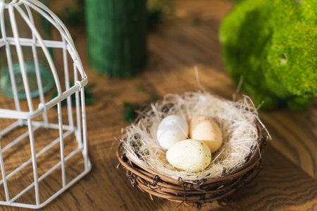 <p>On a wooden table in a decorated nest are three Easter eggseaster, spring, eggs, holiday, green. Easter, spring concept</p>の写真素材