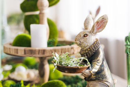 <p>Festive decor, vintage hare on the table for the Easter holiday in green tones. Easter holiday concept, spring, mood</p>の写真素材