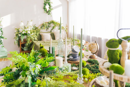 <p>There is a vintage decor of candles, cups, greens on the table. Atmosphere of spring, easter, lunch</p>の写真素材
