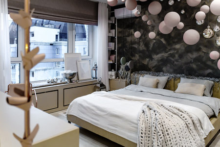 Penthouse bedroom interior in a pink style with a window and large decorative layersの写真素材