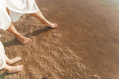 Mother and son are standing near the water by the sea. Travel backgroundの写真素材