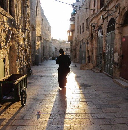 Monk walks down the street to Jerusalem to meet the sunriseの写真素材