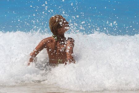 Pretty blonde woman enjoying the Ionian sea in Greece