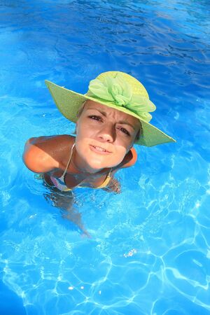 Young woman standing  in a swimming poolの写真素材