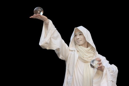 White Wizard manipulating Crystal balls isolated on black background.の写真素材