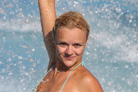 Pretty blonde woman enjoying a swimming pool in Greeceの写真素材