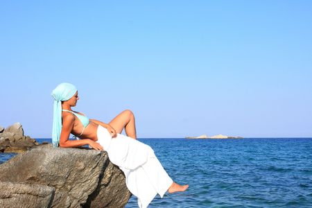 woman relaxing in the afternoon by the sea in Greeceの写真素材