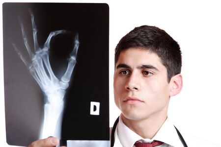 Caucasian mid adult male doctor holding up xrays.

