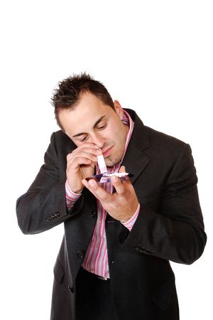 Young businessman sniffing cocaine on a CD/DVD
の写真素材