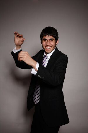 Closeup of a smiling casual business man gesturing の写真素材