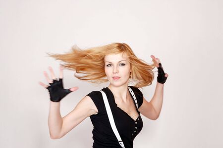 A attractive young woman dancing, hair flying motion blurの写真素材