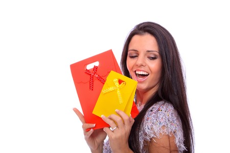 Portrait of a beautiful young woman with shopping bag  isolated over white background