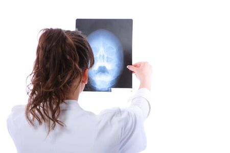 Female doctor looking at an x-ray isolated on white