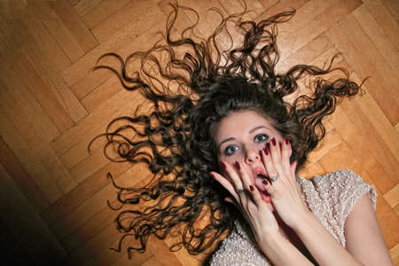 Portrait of a pretty young woman relaxing on the floor