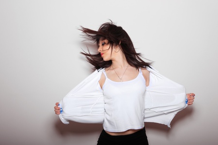 modern dancer poses in front of a light pink wallの写真素材