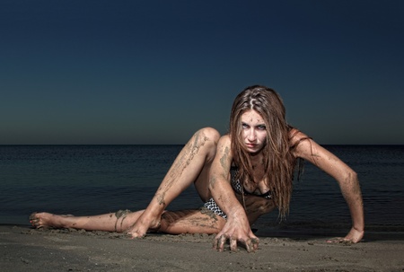 Sexy bikini model posing  on the beach in greece at dawnの写真素材