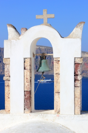 Greek orthodox church with Ferry boat in Santorini, Greeceの写真素材