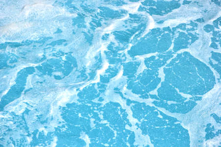 Clean blue sea water with foam