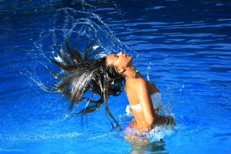 A beautiful woman relaxing in the poolの写真素材
