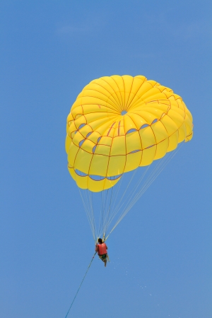 Parachute surfer being hauled by a motorboat in Thailandの写真素材