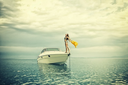 Young sexy woman in bikini enjoying  her private yachtの写真素材