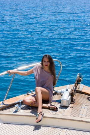 Young sexy woman on her private yachtの写真素材