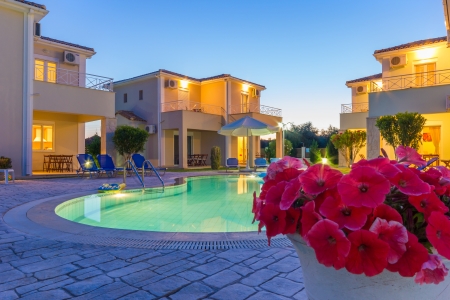 Luxurious villas complex resort with pool in Greece at duskのeditorial素材