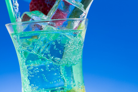 Mint, strawberry and pineapple cocktail over black backgroundの写真素材