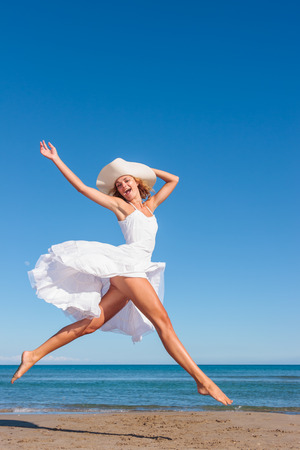 Young woman in white dress on the tropical beachの写真素材