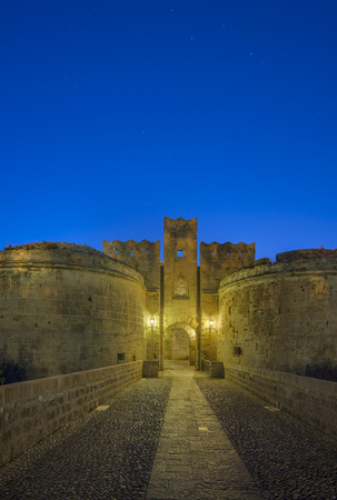 The fortress wall in the harbor at sunset. Rhodes, Greeceの写真素材