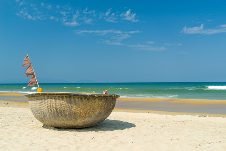 Traditional fishing boat on the beach of Hoi An Da Nang Vietnamの写真素材
