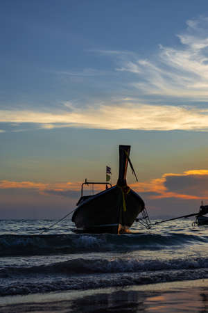 Traditional long-tail boat on the beach in Thailandの写真素材
