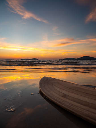 Surfboard on the beach at sunsetの写真素材