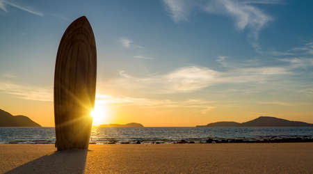 A Surfboard on the beach at sunsetの写真素材