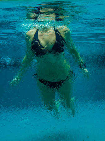 Woman in bikini at swimming pool underwaterの写真素材