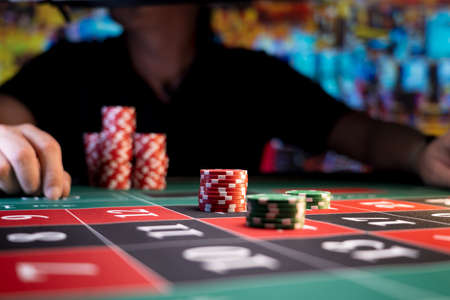 Man playing at the roulette table at the casinoの写真素材