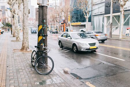 Road bicycle on city street. park at tree sideroad, urban scene, road bike and car, cycling or commuting in city urban environment, ecological transportation . Seoul, South Korea.の写真素材
